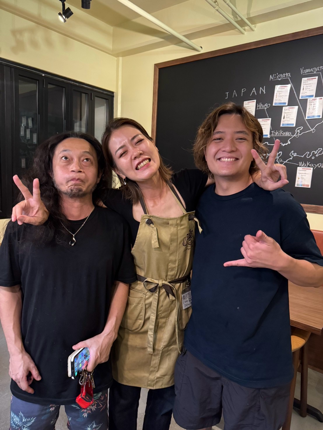 Three people together at LaLa, beside the Japan map.