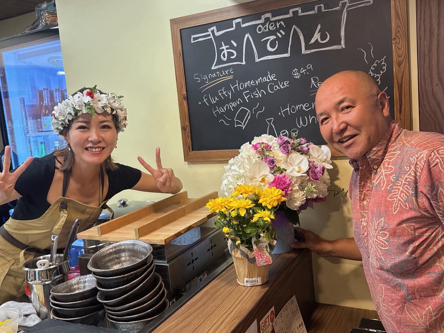 Flowers and smiles across the LaLa counter.