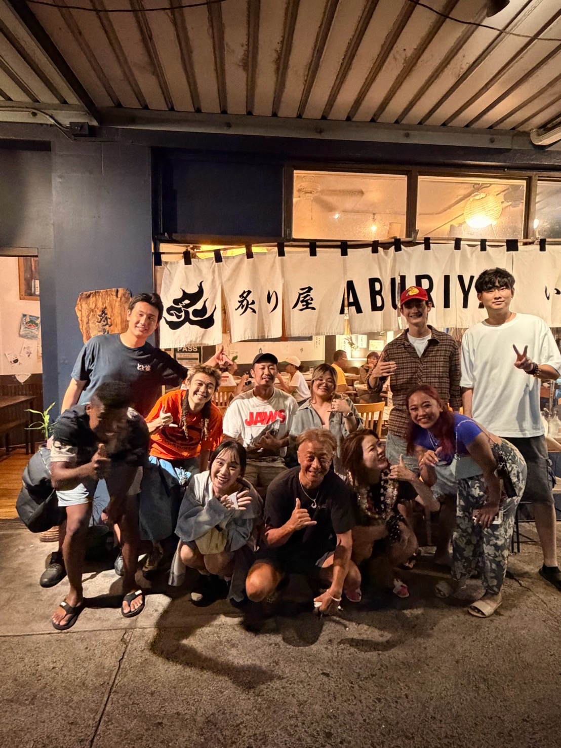 A group photo outside a restaurant.